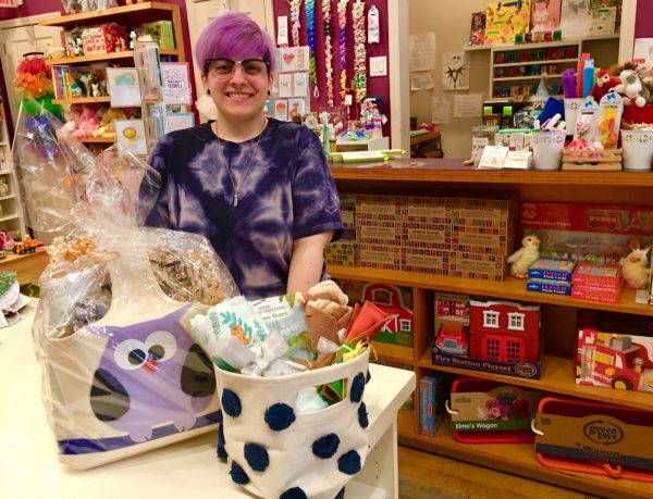 Elizabeth Stassi shows me gift baskets, which are big sellers at LuLu’s For Baby. Eagle photo by Lore Croghan