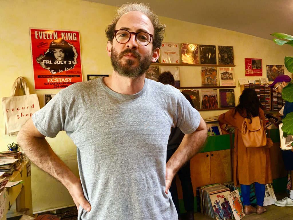 Bene Coopersmith, owner of the Record Shop, suggests that in tearing down the Lidgerwood Building, UPS is erasing Red Hook’s history. Eagle photo by Lore Croghan