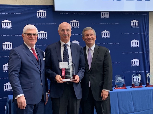 Jonathan Plasse (center), a retired senior partner at Labaton Sucharow, was honored by the New York State Bar Association with an award for his pro bono services helping families facing foreclosure. Here he is seen with NYSBA President Michael Miller and President-Elect Henry Greenberg. Photo courtesy of Jonathan Plasse