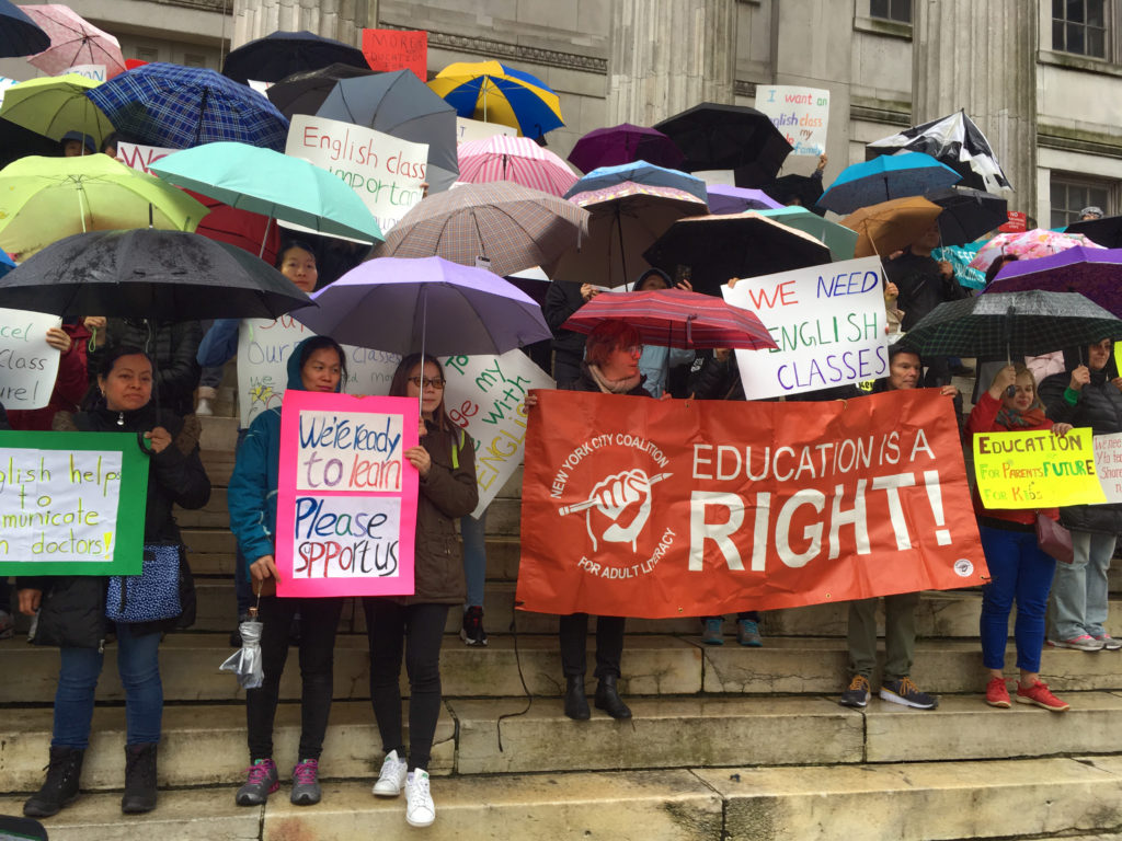 English language learners and their teachers rallied in the rain at Brooklyn Borough Hall on Monday. Eagle photo by Mary Frost