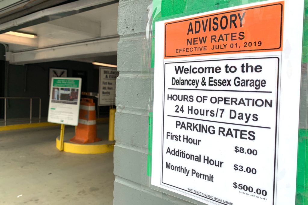 A municipal parking garage in the Lower East Side announces a monthly rate hike. Photo: Jose Martinez /THE CITY
