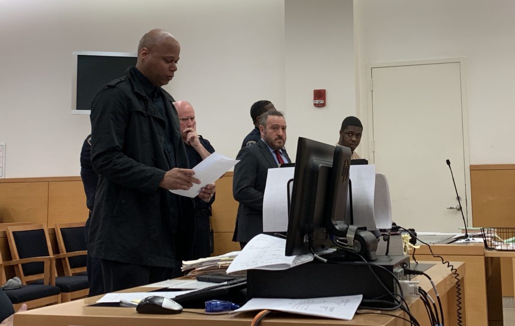 Reginald Moise (right) listens as a family member of Tiarah Poyau (left) speaks at his sentencing. Eagle photo by Noah Goldberg.