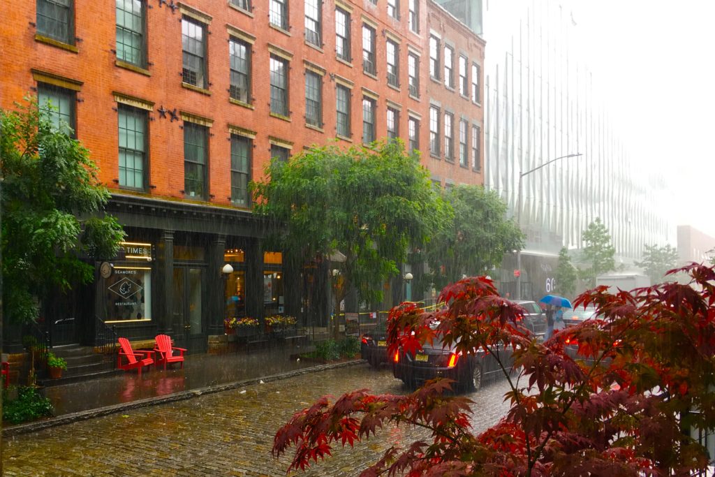 The cobblestone street outside Almondine Bakery looks beautiful in a sudden downpour. Eagle photo by Lore Croghan