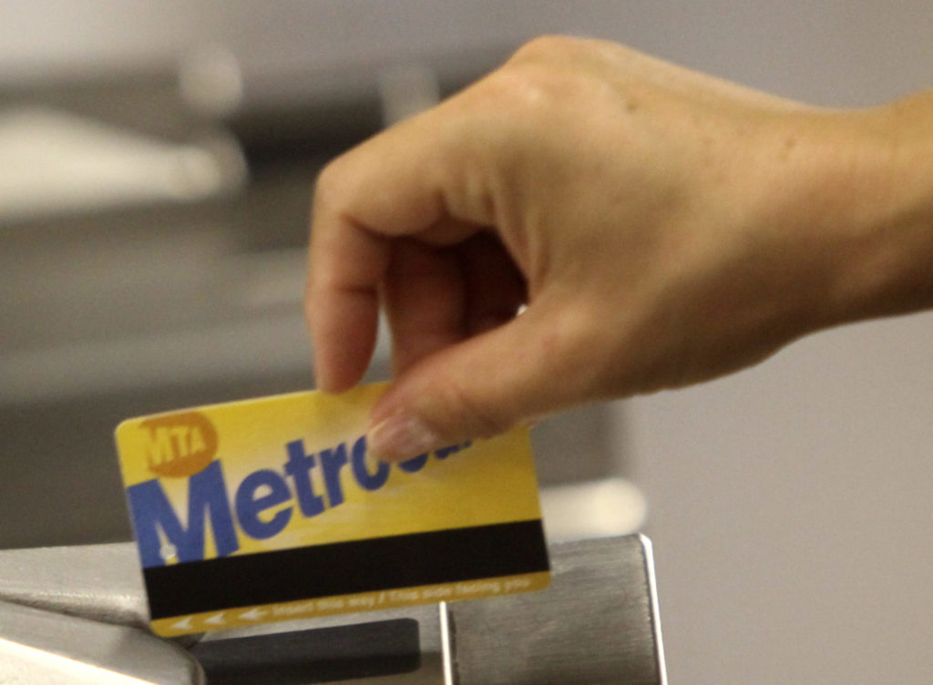 A subway rider swipes a MetroCard. AP Photo/Seth Wenig