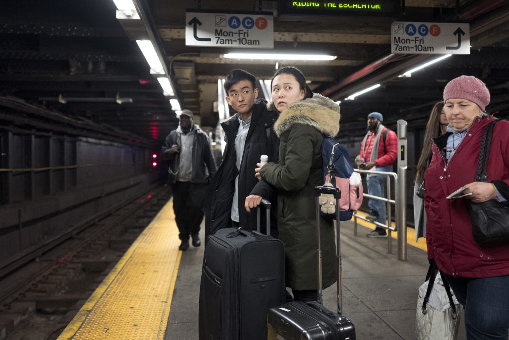 Two travelers wait with their suitcases for a subway at the Jay St.-MetroTech station. AP Photo/Mark Lennihan