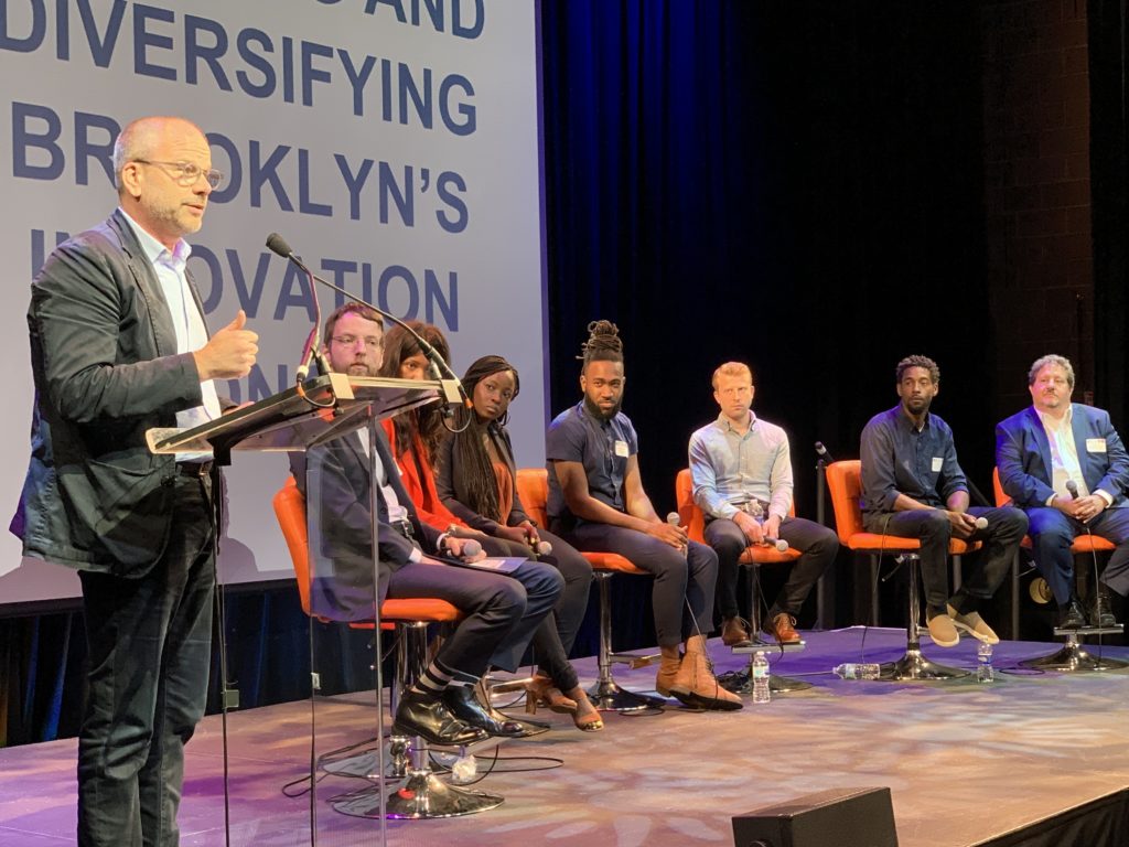 Andrew Kimball, CEO of Industry City, left, speaks about expanding opportunity in Brooklyn’s booming “innovation economy” at a symposium presented by Center for an Urban Future and other organizations on June 21 in Downtown Brooklyn. Shown: Members of Panel 2. Eagle photo by May Frost