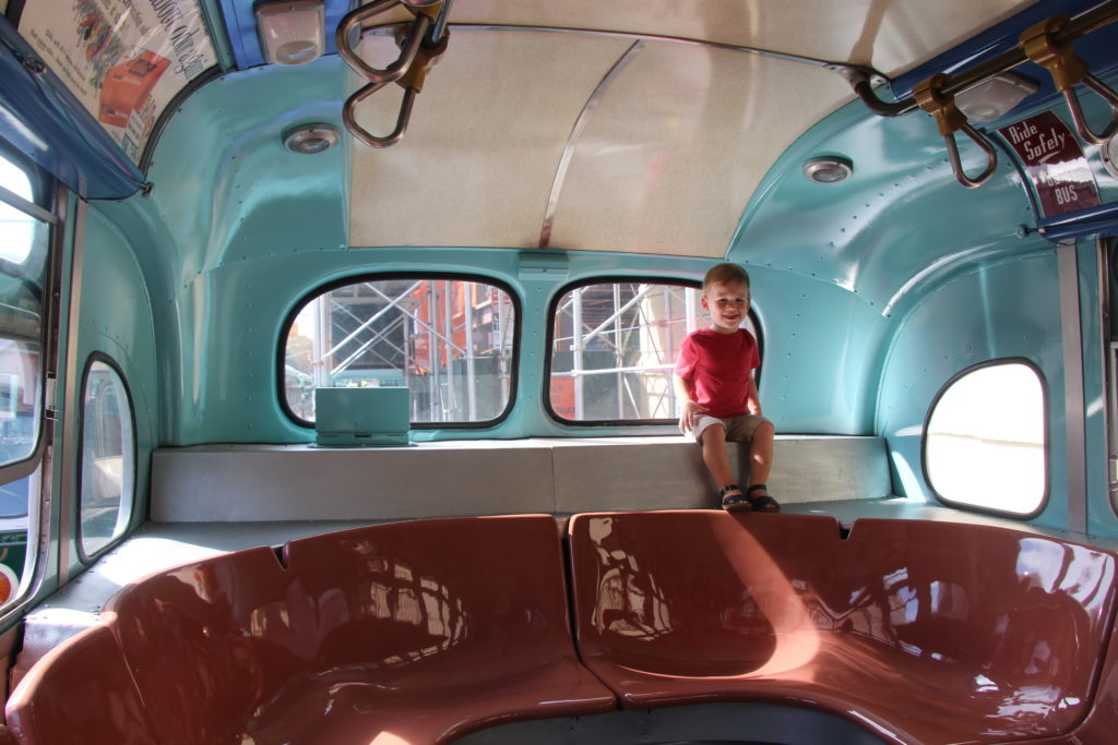A boy rides Bus 9098, a model from 1958, at a previous Transit Museum Bus Festival. Photo courtesy of the New York Transit Museum