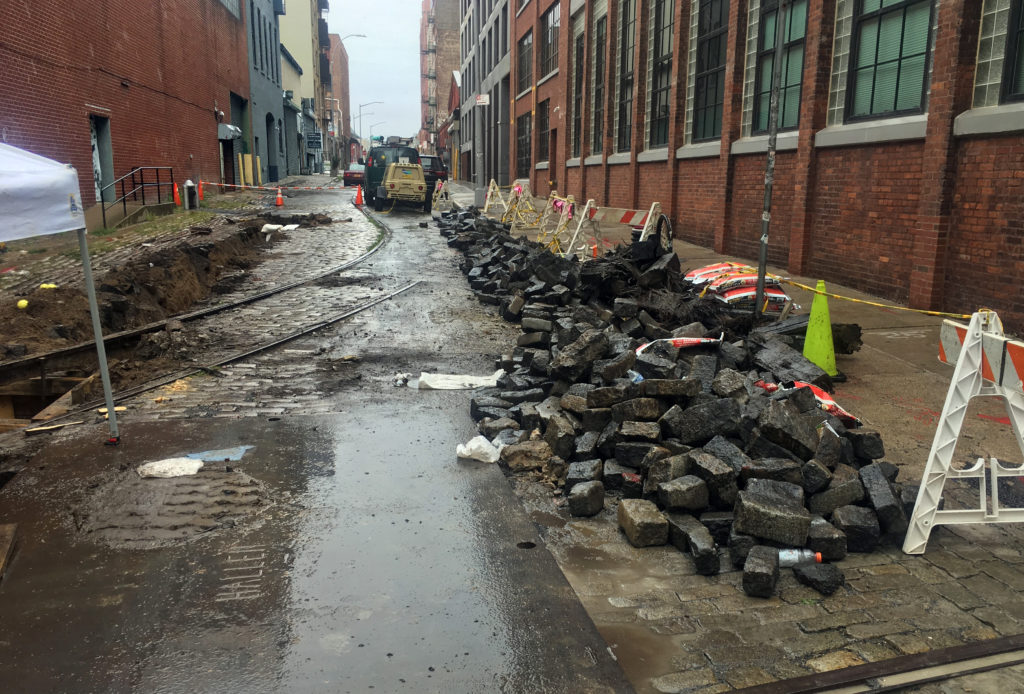 A National Grid contractor tore up the historic Belgian block at the corner of Plymouth and Jay streets in DUMBO earlier this month. Photo by Octavio Molina