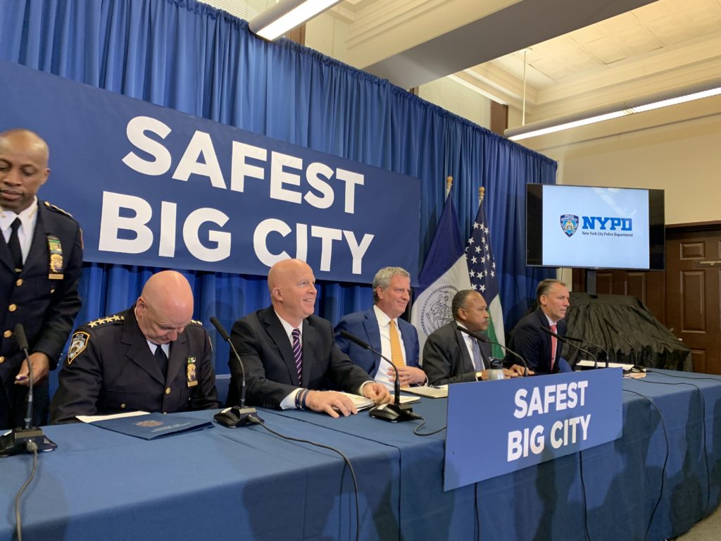 Mayor Bill de Blasio (center) and Police Commissioner James P. O'Neill (second from left) speak with reporters at a monthly crime briefing. Eagle photo by Noah Goldberg