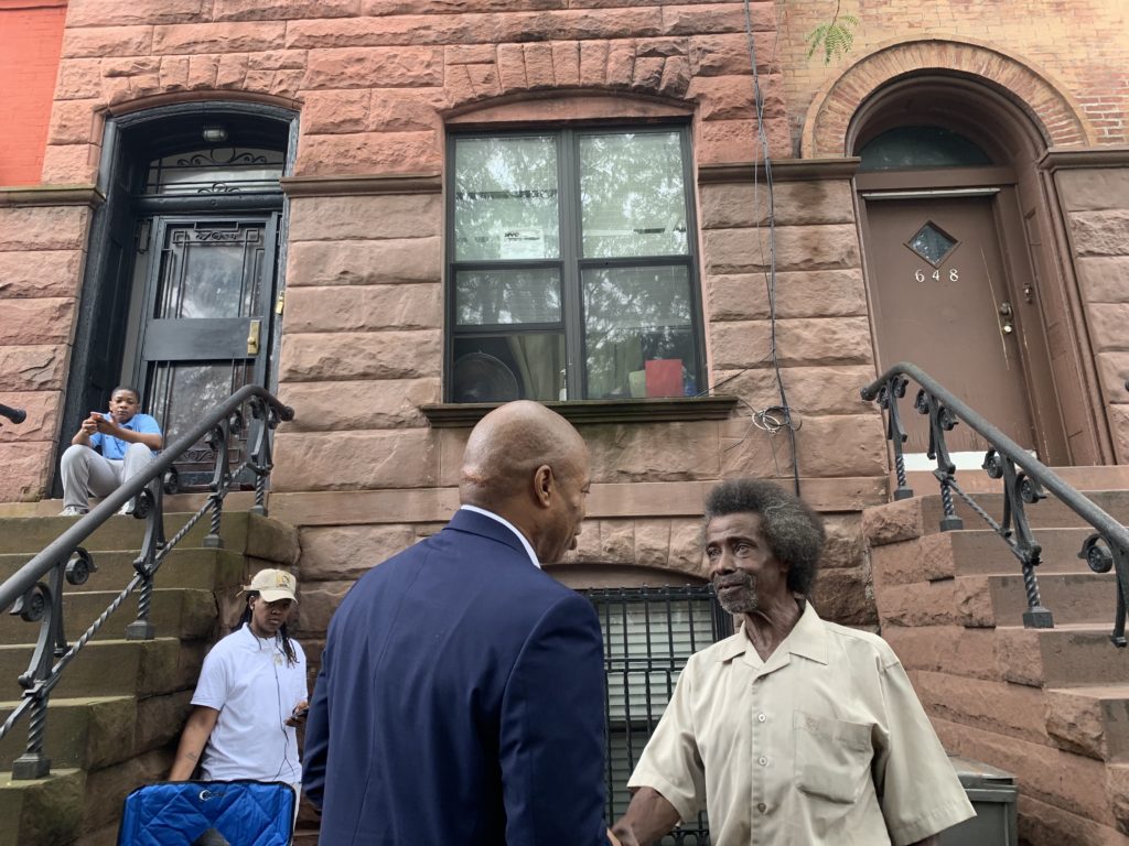 Brooklyn Borough President Eric Adams meets Dairus Griffiths outside the home Griffiths claims he was tricked into selling far below market rate. Eagle photo by Noah Goldberg
