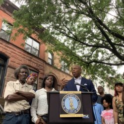 Brooklyn Borough President Eric Adams (center) announces a GoFundMe page to help a Bedstuy family with legal fees a day after they claimed they were the victims of deed theft. Eagle photo by Noah Goldberg