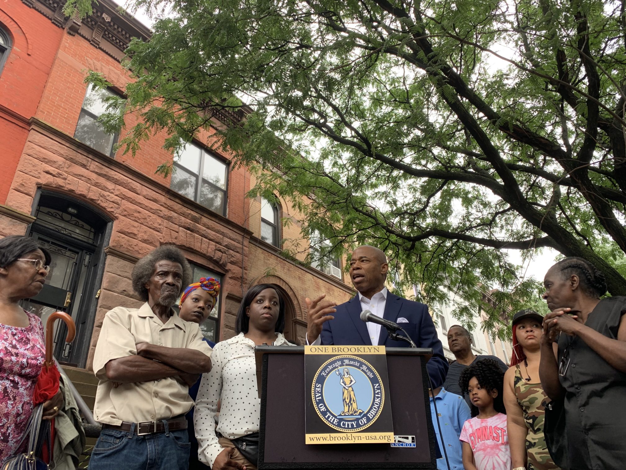 Brooklyn Borough President Eric Adams (center) announces a GoFundMe page to help a Bedstuy family with legal fees a day after they claimed they were the victims of deed theft. Eagle photo by Noah Goldberg