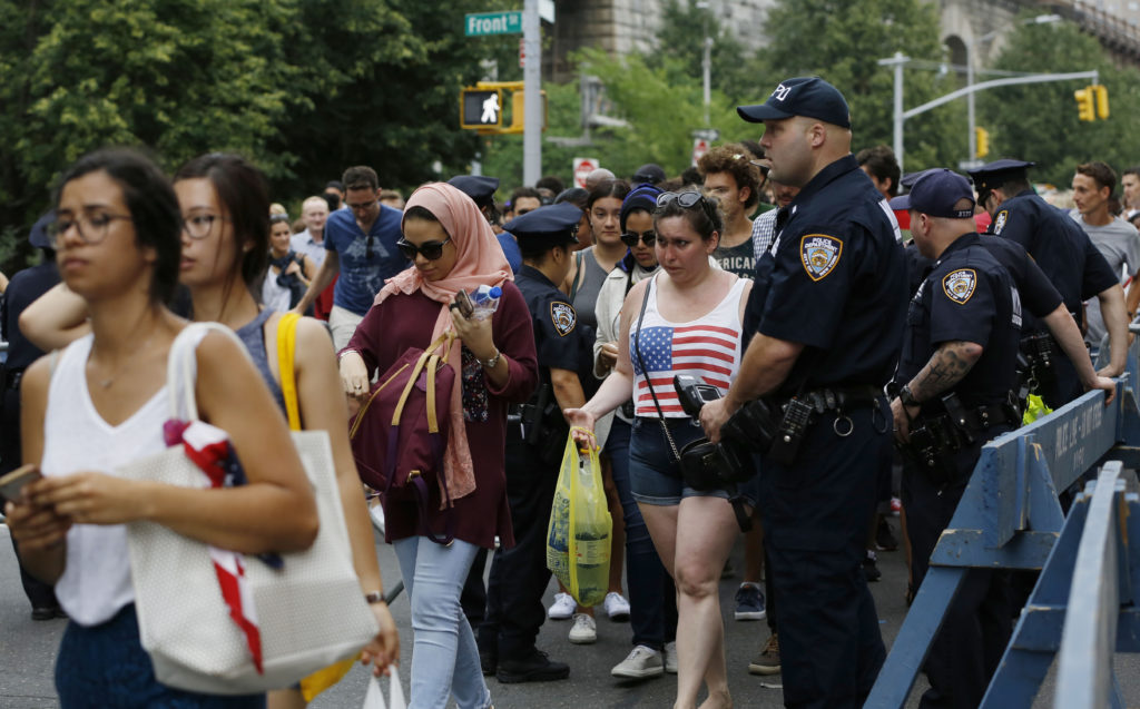 Crowds of people file through a police checkpoint for Fourth of July 2016. AP Photo/Kathy Willens