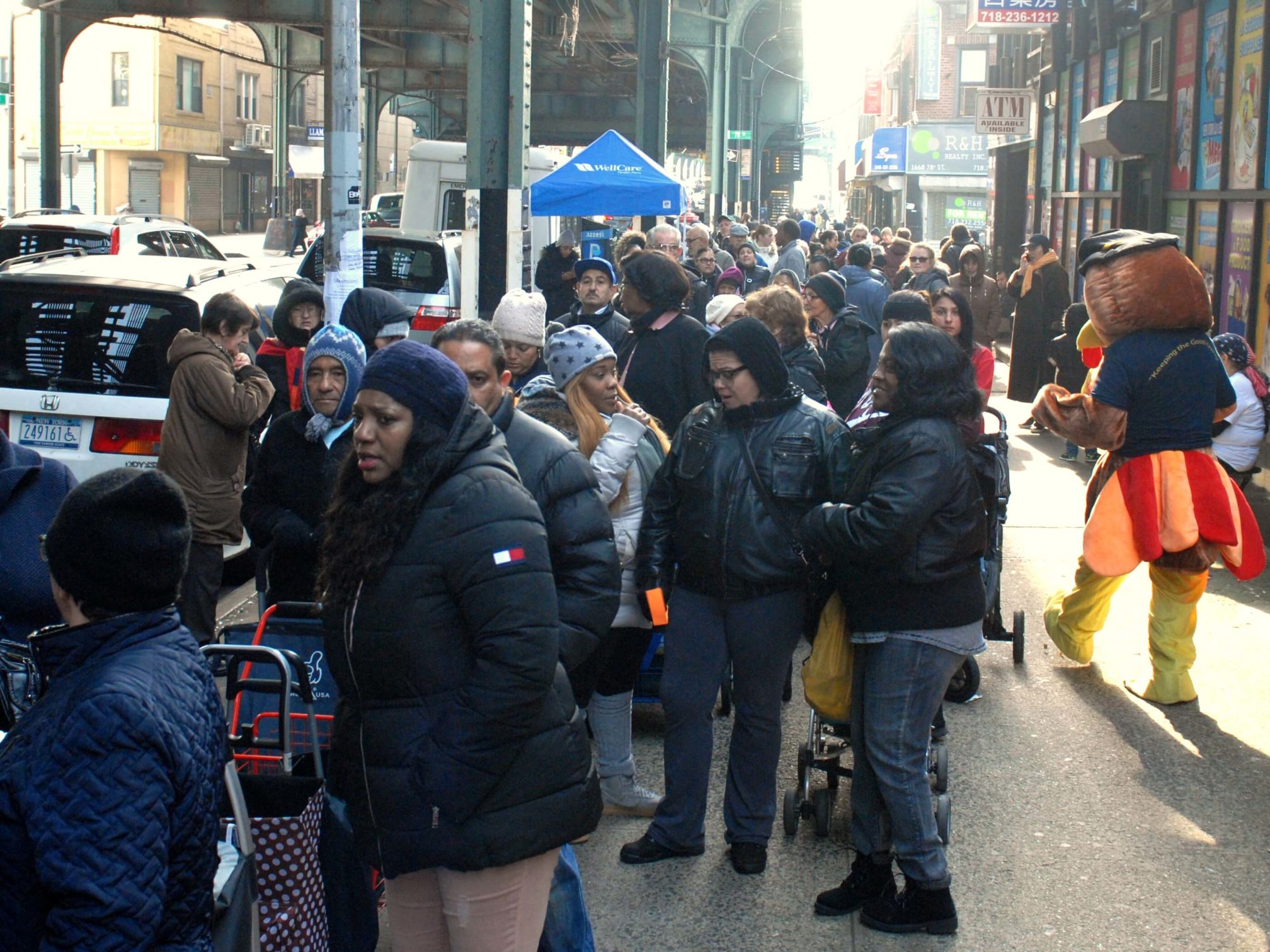 Hundreds of people lined up on New Utrecht Avenue outside Reaching-Out for Thanksgiving turkeys last year. Eagle file photo by Arthur de Gaeta