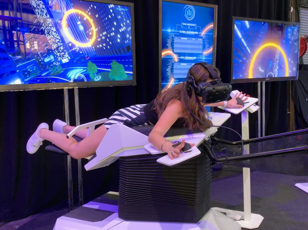 Attendees felt like they were flying through a virtual city in Allianz’s Birdly virtual reality simulator. The tilt of the wings and body of the simulator are controlled by the pilot, who is visually immersed through a head-mounted VR display. Eagle photo by Mary Frost