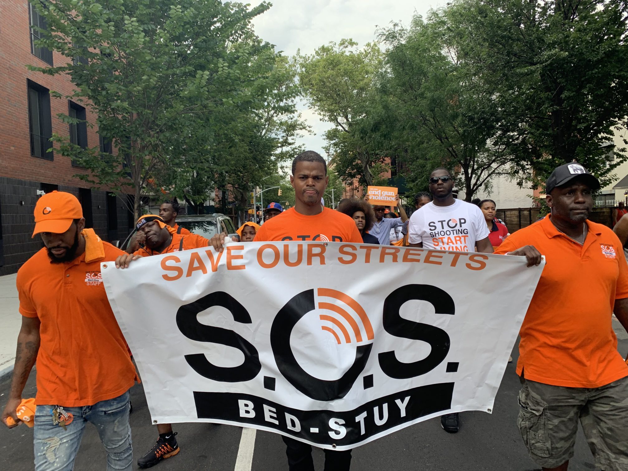 Organizers with SOS Bed-Stuy marched from Herbert Von King Park to Restoration Plaza to mark the end of gun violence awareness month. Eagle photo by Noah Goldberg