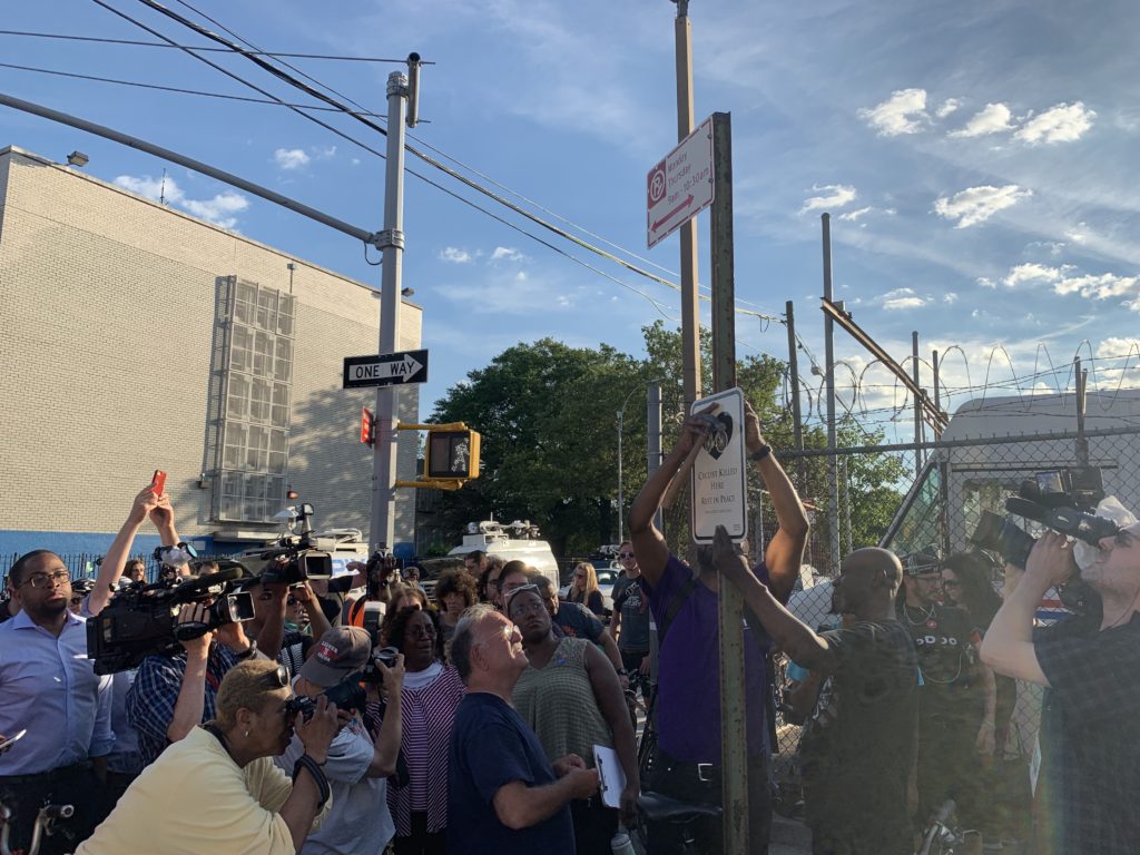 Politicians and safe streets activists watch as a plaque is erected in honor of Ernest Askew, who was struck and killed at the corner of Sutter Avenue and Chester Street in Brownsville Thursday. Eagle photo by Noah Goldberg