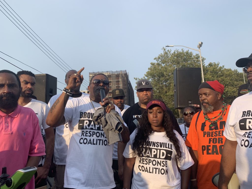 Andre Mitchell (left) speaks at a march against gun violence July 29, 2019, just two days after two or more shooters left one dead and 11 others injured in a shooting at Brownsville's Old Timer's Day. Eagle photo by Noah Goldberg
