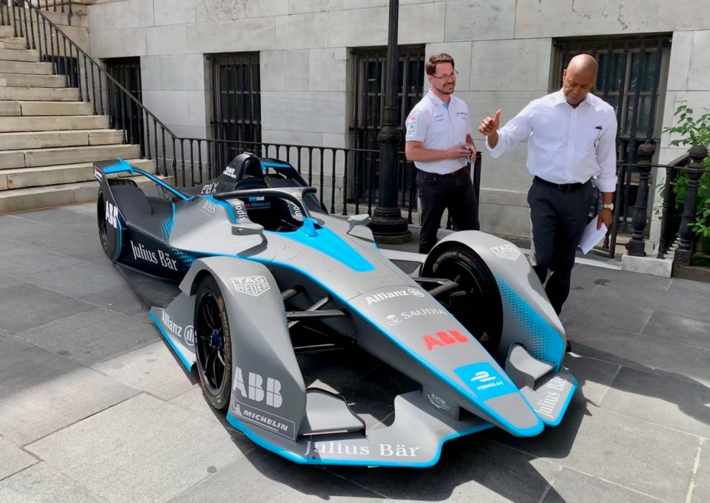 Brooklyn Borough President Eric Adams gives the thumbs up to the Gen 2 electric racing vehicle on display at Borough Hall on Tuesday. With the BP is Formula-E advisor Michael Hopper. Eagle photo by Mary Frost
