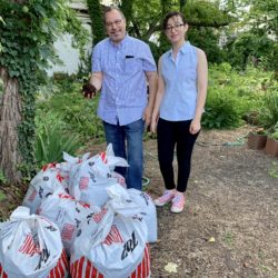 John Quadrozzi Jr., left, and his daughter Xiana rip open one of the first bags of composted manure delivered to Red Hook’s Backyard Community Garden on Sunday. Xiana is a partner with her dad in Prospect Park Stable. Eagle photo by Mary Frost