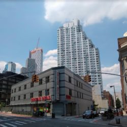 Looking northwest from Fulton Street and Rockwell Place. The remaining building on the 1.73-acre lot would be demolished. The proposed 942-foot tower would be more than twice the height of the stepped, 405-foot 80 DeKalb tower adjoining the lot, and 222 feet taller than the 720-foot Brooklyn Point tower in the background. Photo by Norman Oder