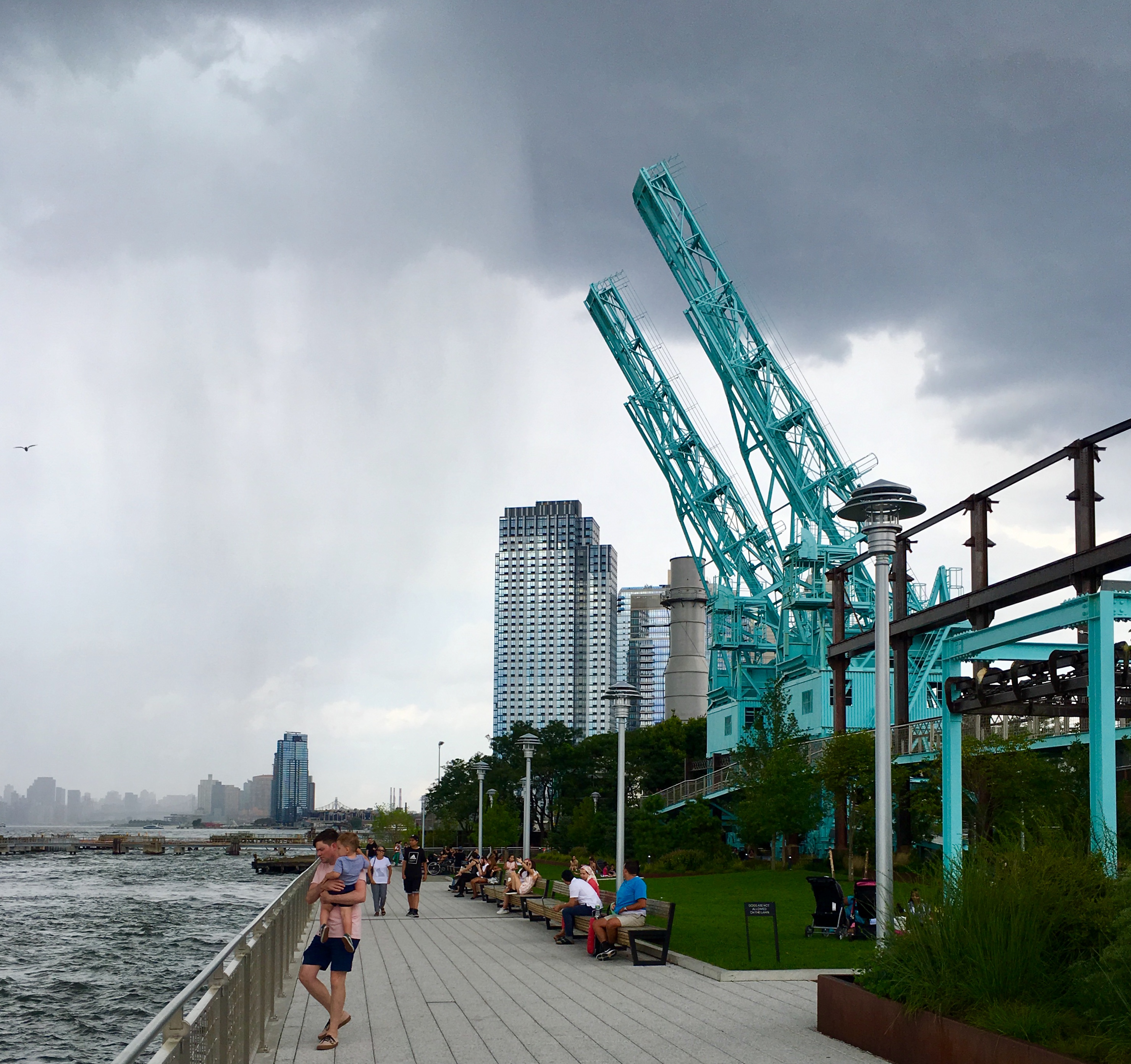Domino Park’s gantry cranes stand tall as a storm approaches. Eagle photo by Lore Croghan