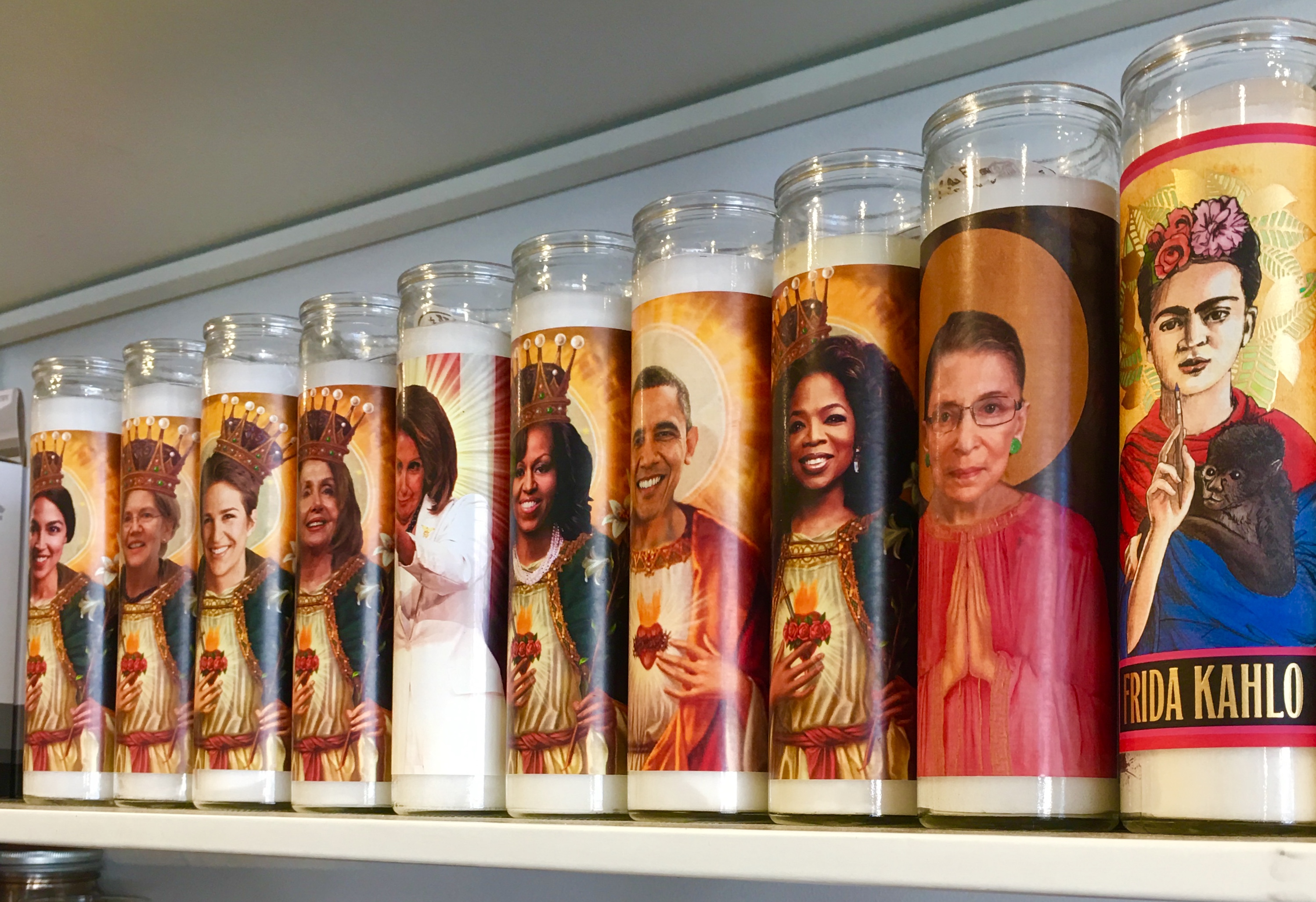 A votive candle featuring Presidential candidate Elizabeth Warren (second from left) is the top-seller among a feminist-friendly lineup of votive candles at gift shop Awesome Brooklyn. Eagle photo by Lore Croghan