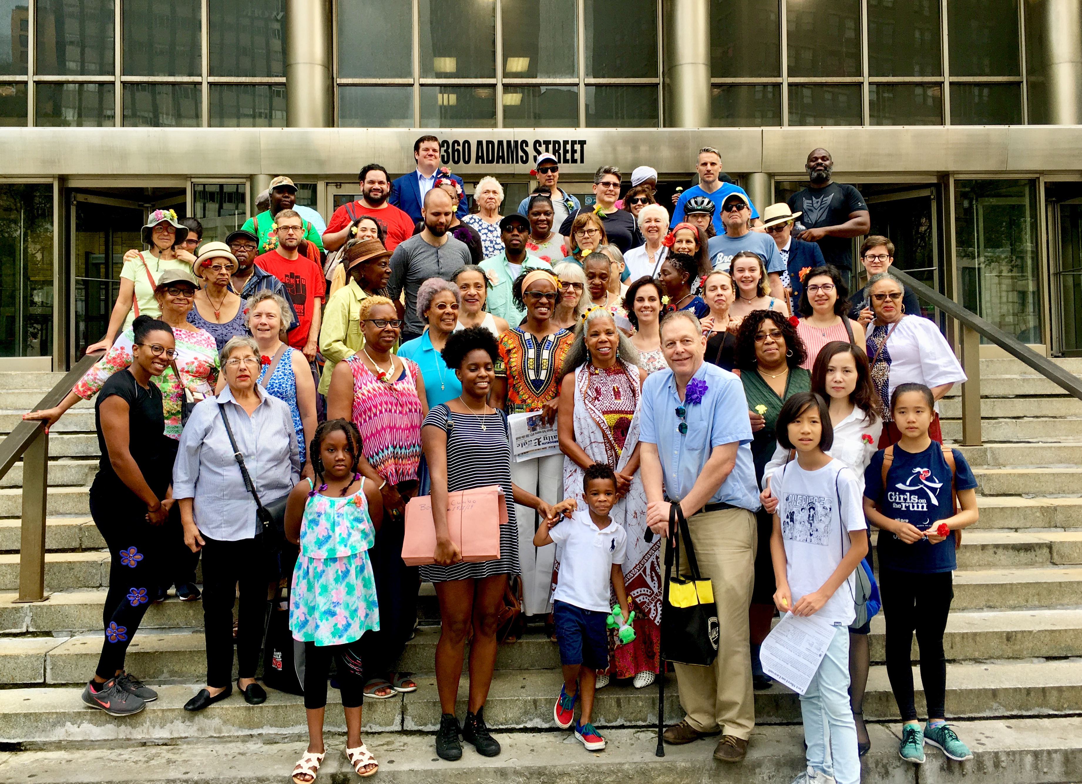 Activist Alicia Boyd, who’s in the second row of stairs in the center of the picture, poses with people who are concerned about shadows that could be cast on the Brooklyn Botanic Garden by nearby developments. Eagle photo by Lore Croghan 