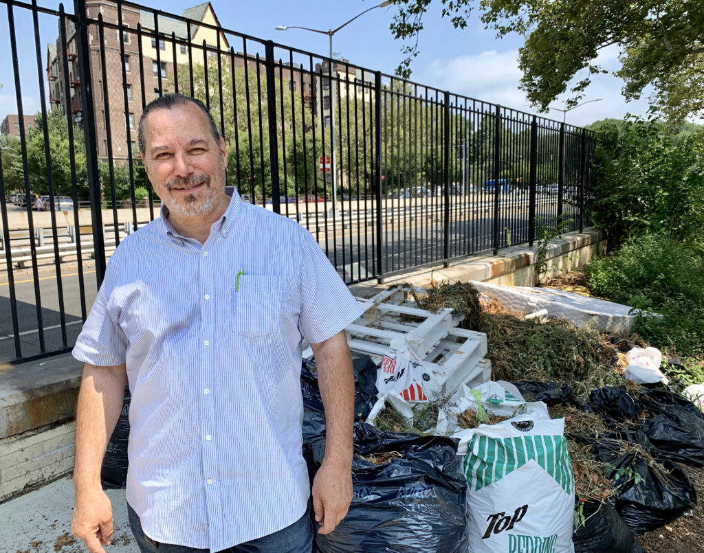 Brooklyn industrialist John Quadrozzi, Jr. stands in front of old tires, discarded mattresses and other illegally debris on the Ocean Parkway access road behind his Prospect Park Stable in Windsor Terrace. Eagle photo by Mary Frost