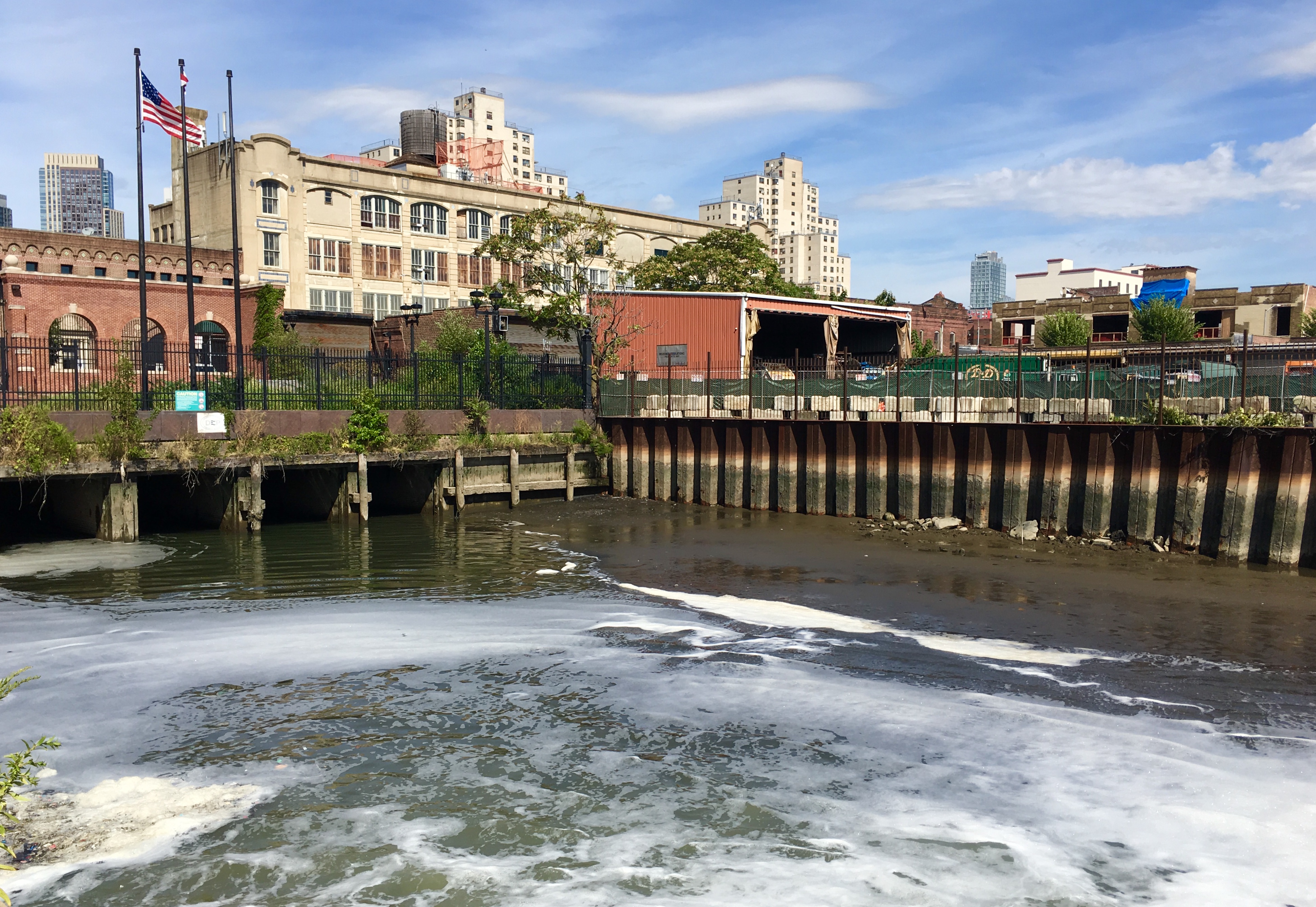 Preservationists consider the R.G. Dun & Company Building, the white building seen here from the banks of the Gowanus Canal, to be landmark-worthy. Eagle photo by Lore Croghan