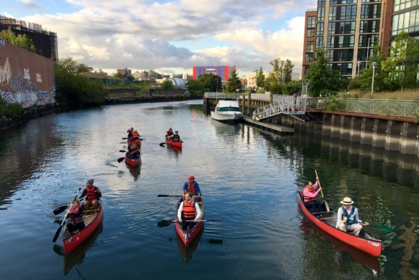 The readers for Whitman in Canoes on the Gowanus at Dawn arrive at the Carroll Street Bridge. Eagle photo by Lore Croghan