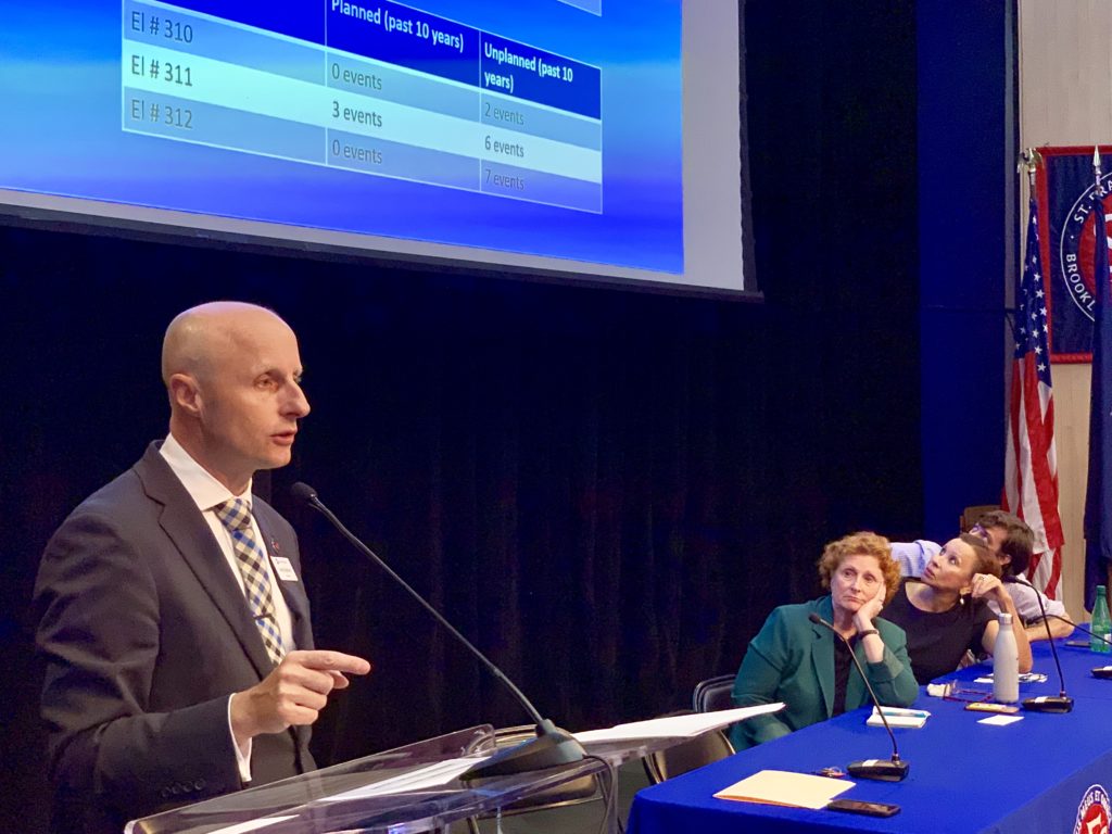 MTA President Andy Byford presents options for replacing the elevators at the Clark Street Subway station, at a town hall Monday night. In the background are Assemblymember Jo Anne Simon, U.S. Rep. Nydia Velazquez and Councilmember Stephen Levin. eagle photo by Mary Frost