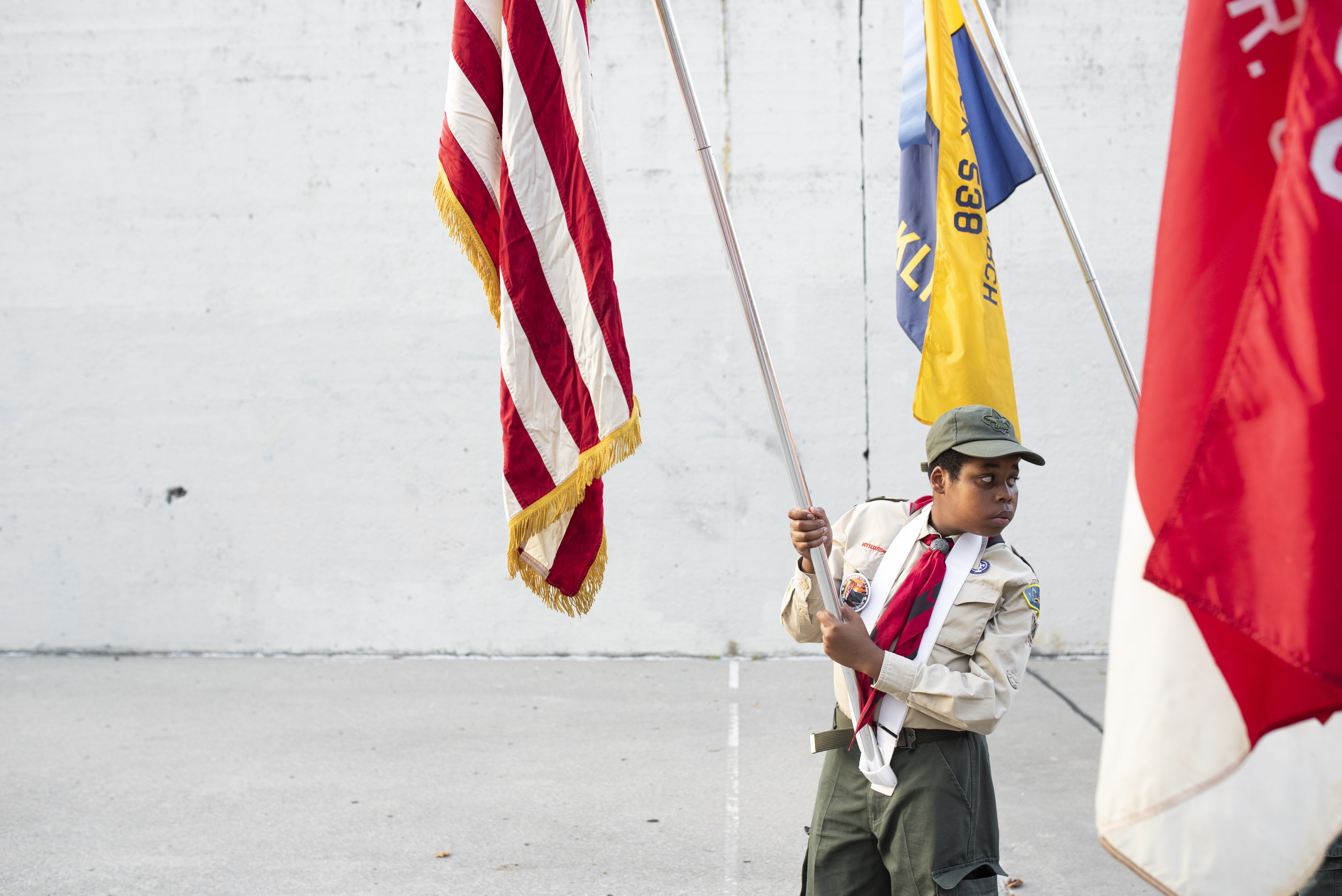 A Boy Scout holds an American flag at Sheepshead Bay’s 9/11 commemoration. Eagle photo by Mark Davis