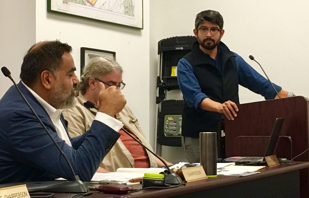 City Councilmember Carlos Menchaca, at the podium, addresses a CB7 meeting. That’s CB7 Chairperson Cesar Zuniga at left. Eagle photo by Lore Croghan