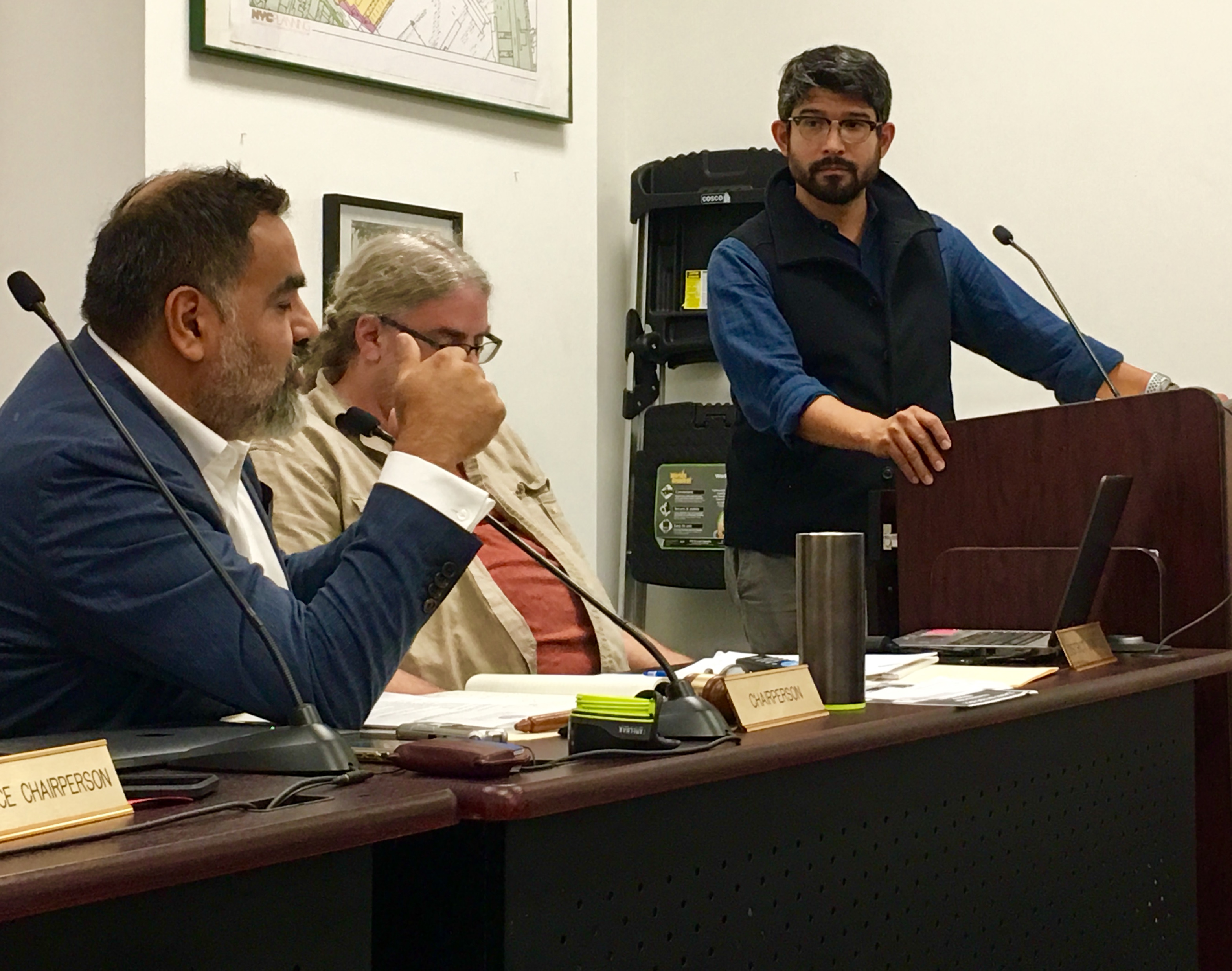 City Councilmember Carlos Menchaca, at the podium, addresses a CB7 meeting. That’s CB7 Chairperson Cesar Zuniga at left. Eagle photo by Lore Croghan