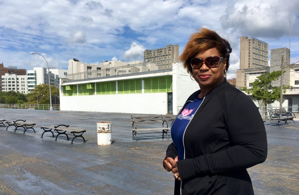 Coney Island resident Dionne Brown wants the Parks Department to repair this section of the Boardwalk, which is covered with a plywood deck. Eagle photo by Lore Croghan