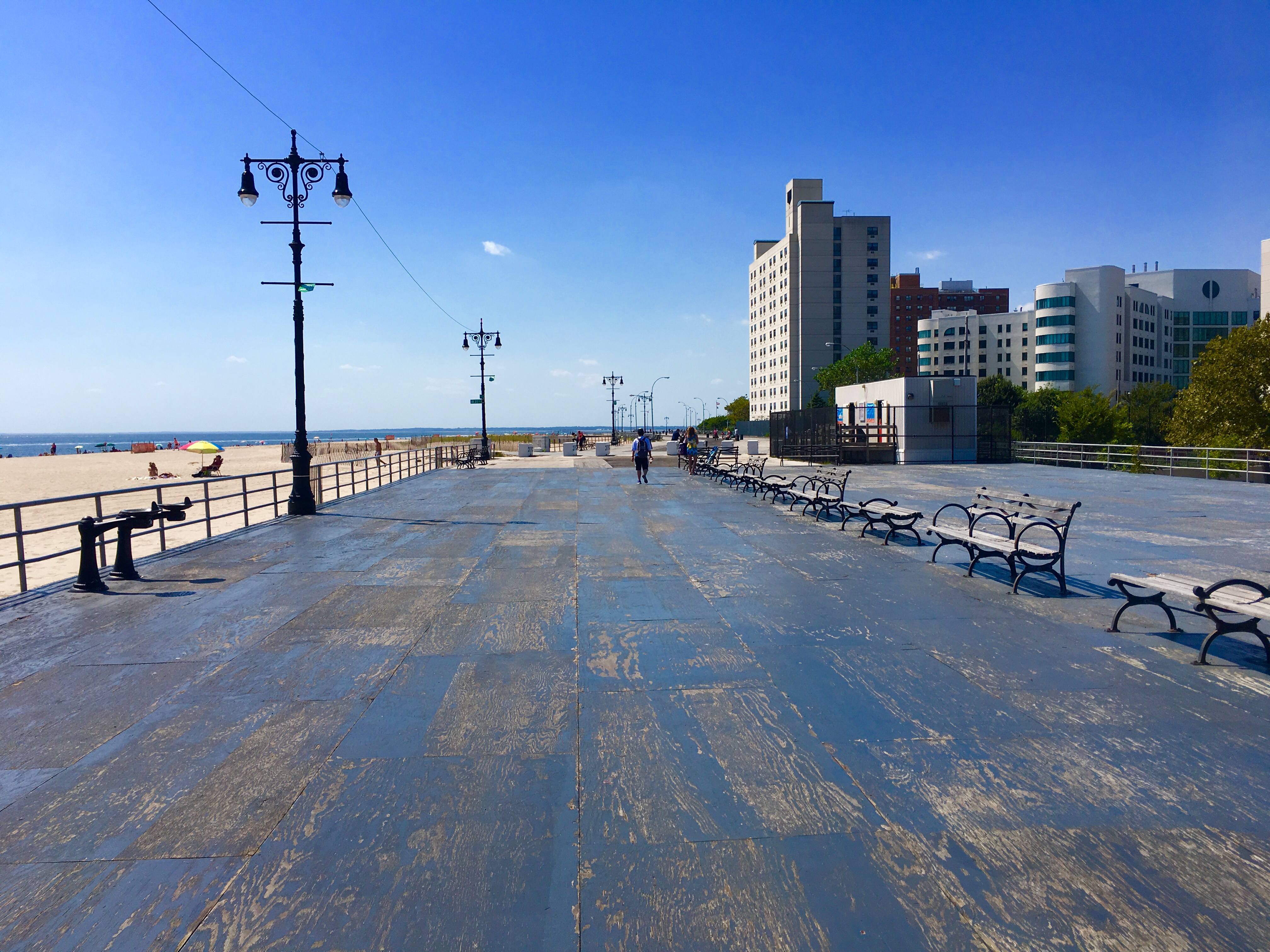 A few blocks away from Red Apple Group’s new apartment complex, a plywood deck stretches over the damaged Coney Island Boardwalk. Eagle photo by Lore Croghan