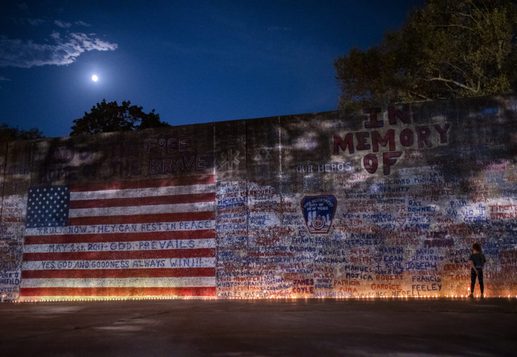 Candles illuminate Sheepshead Bay’s 9/11 memorial mural on the 18th anniversary of the terrorist attacks. Eagle photo by Mark Davis