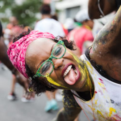 A parade participant dances her way down Empire Boulevard.