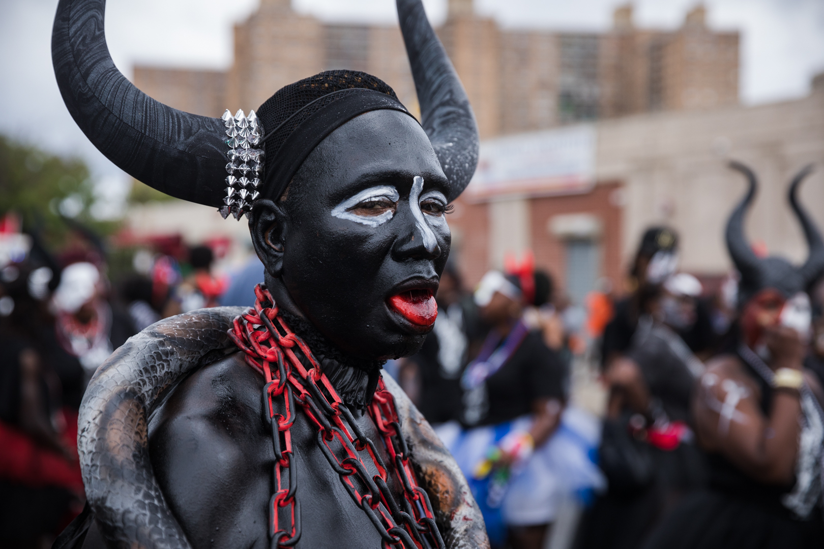 A participant dressed in a devil costume poses.