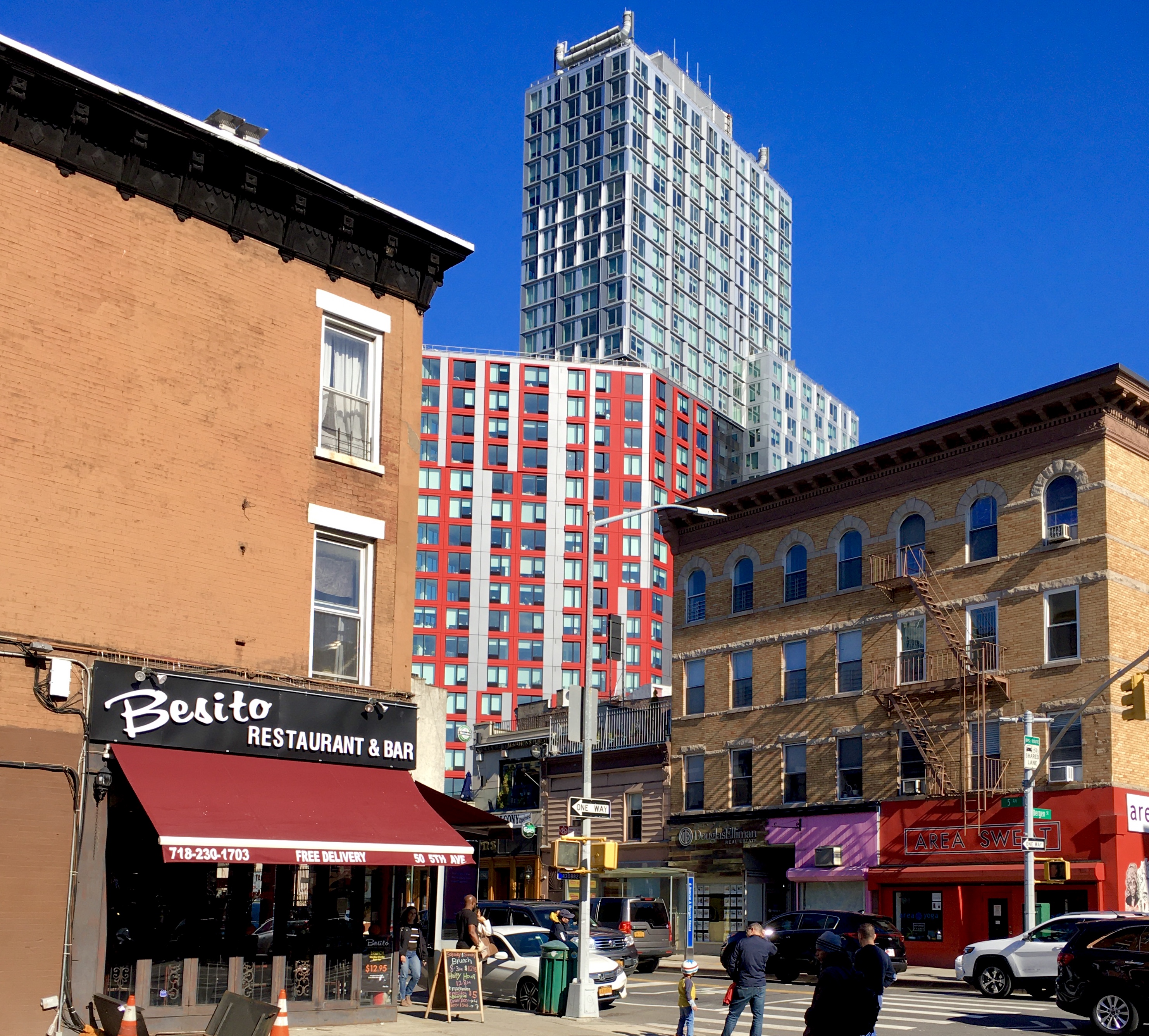 Low-rise buildings at the intersection of Fifth Avenue and Bergen Street frame a view of Atlantic Yards high-rises. Eagle photo by Lore Croghan