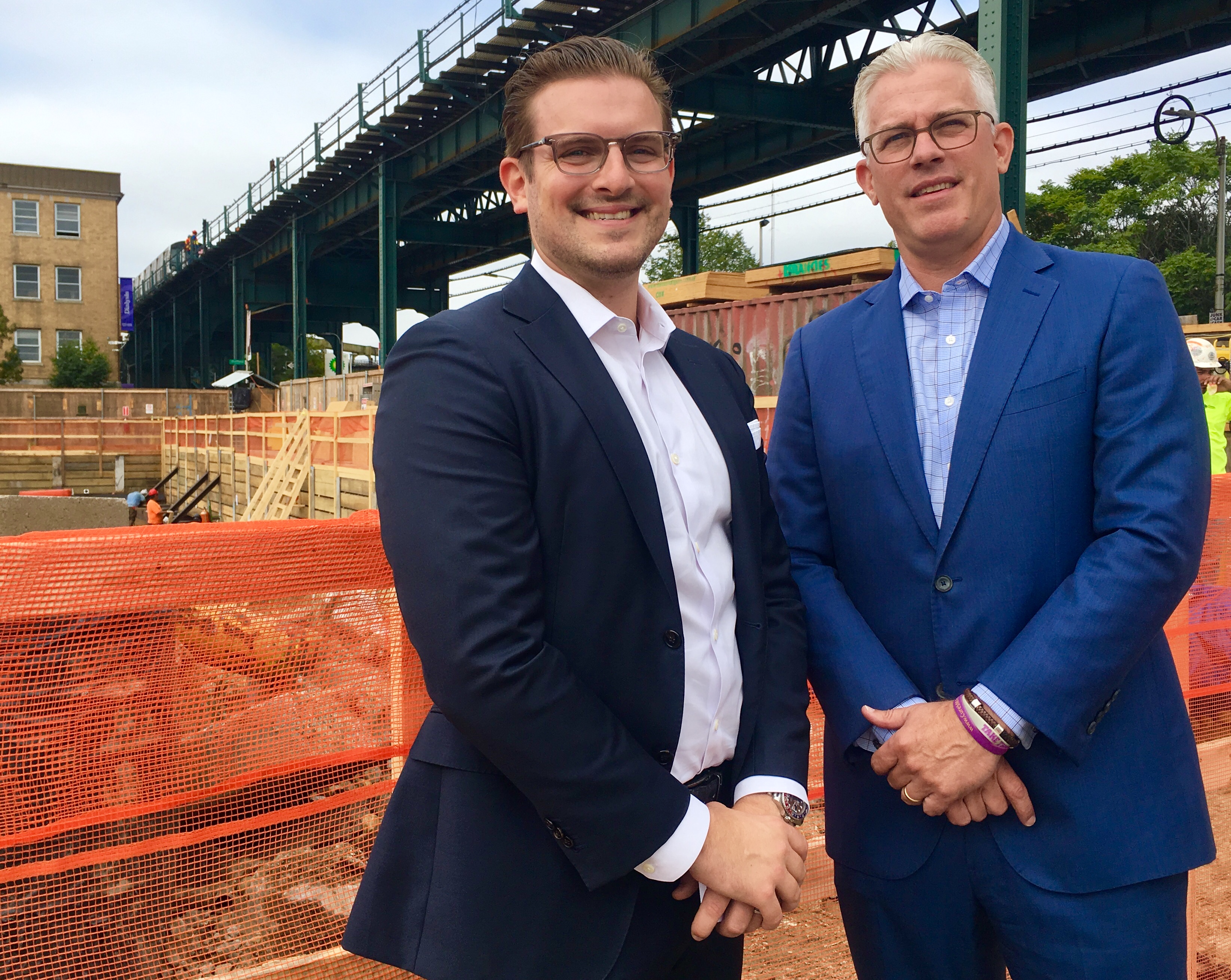 Pennrose executives Dylan Salmons (at left) and Timothy Henkel at 50 Pennsylvania Ave., where their firm is constructing a 218-unit apartment building. Eagle photo by Lore Croghan