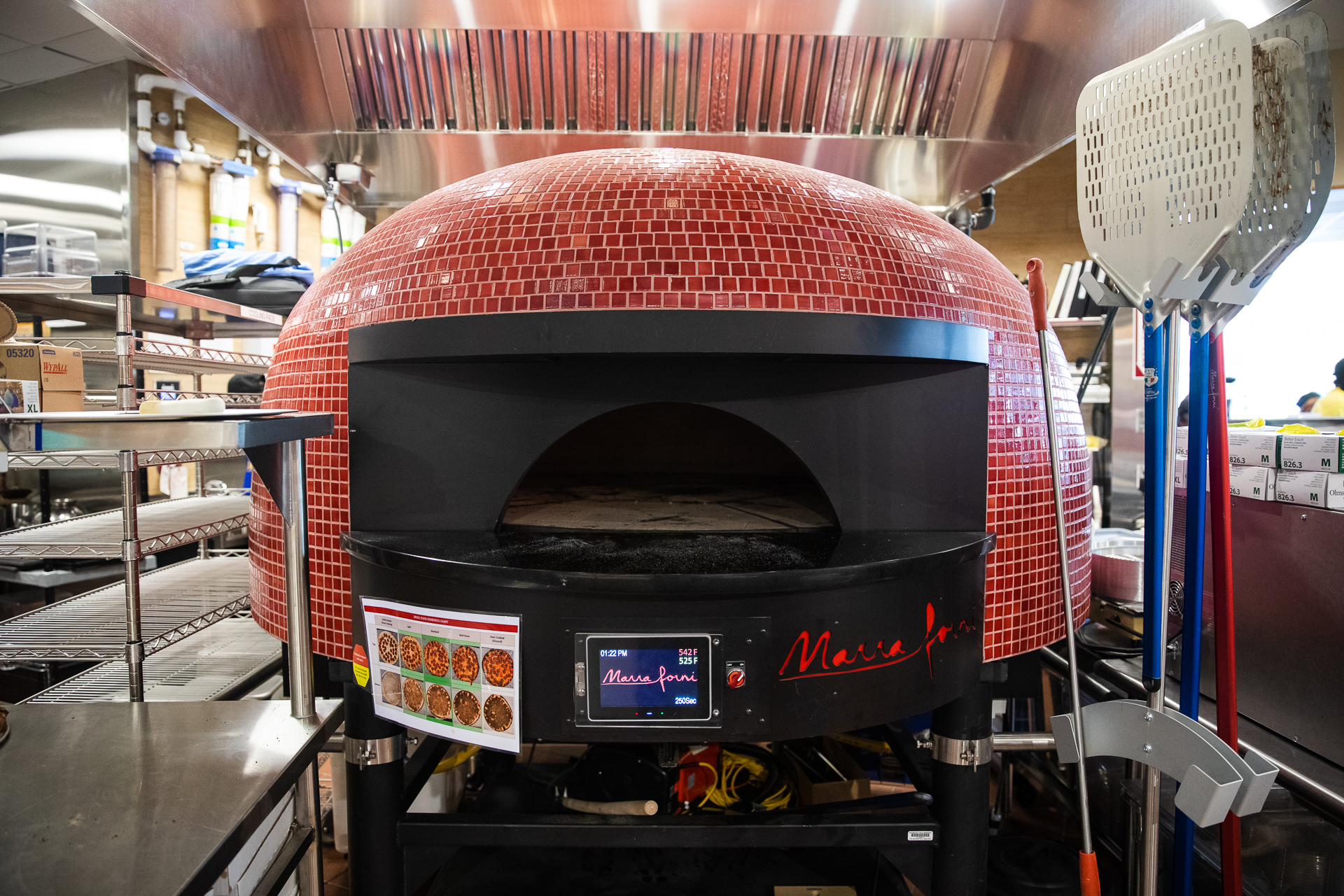  It takes about four minutes to bake a pizza in this oven. Eagle photo by Paul Frangipane