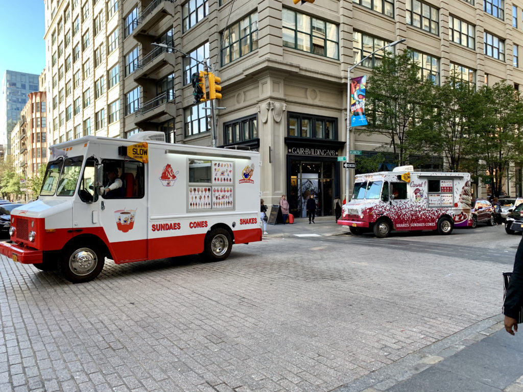 Over this past summer, a record number of diesel-powered ice cream trucks have jammed the streets of the DUMBO and the Fulton Ferry historic districts, and residents are sick of the noise and fumes. Shown: Rival ice cream trucks roam the streets of DUMBO looking for a place to park. Eagle photo by Mary Frost