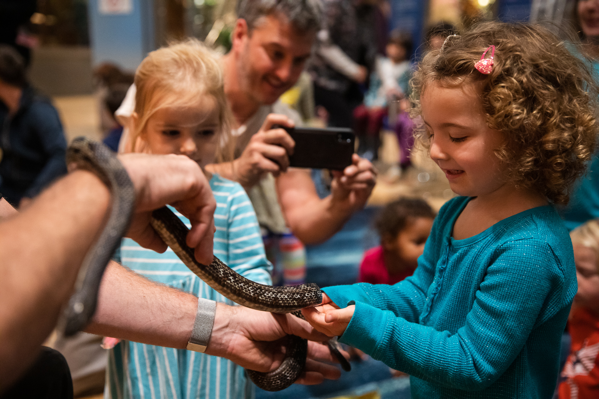 Kids check out Squiggles the black rat snake. Eagle photo by Paul Frangipane