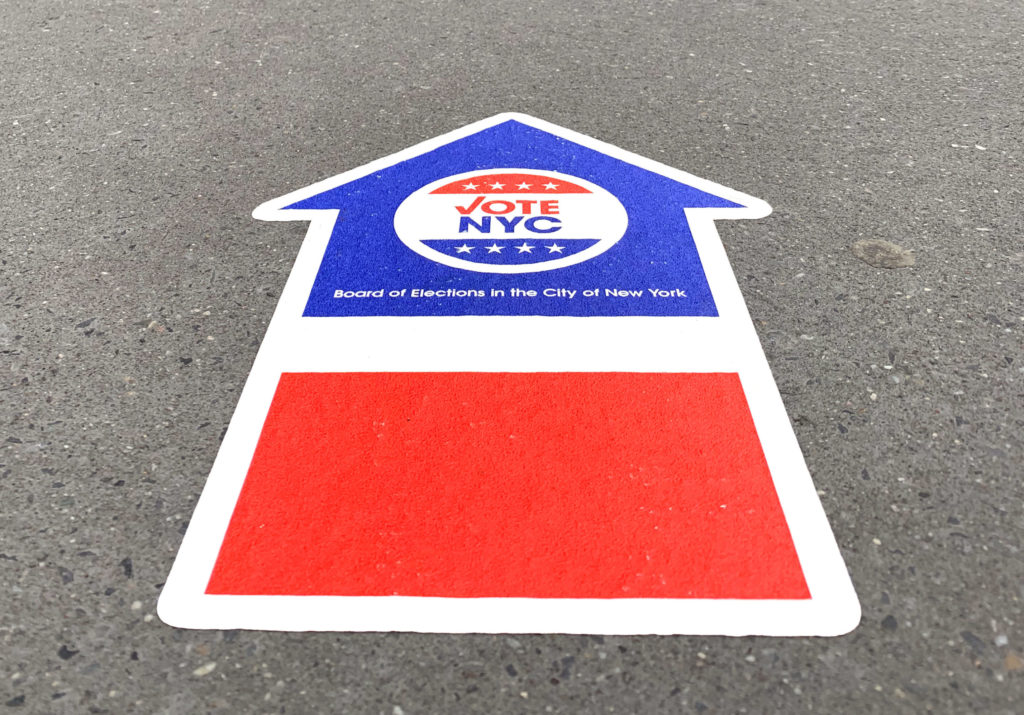 It was easy to find the early voting site in Downtown Brooklyn on Monday. Red, white and blue Vote NYC arrows are stuck onto the sidewalks surrounding the Urban Assembly School for Law and Justice. Eagle photo by Mary Frost