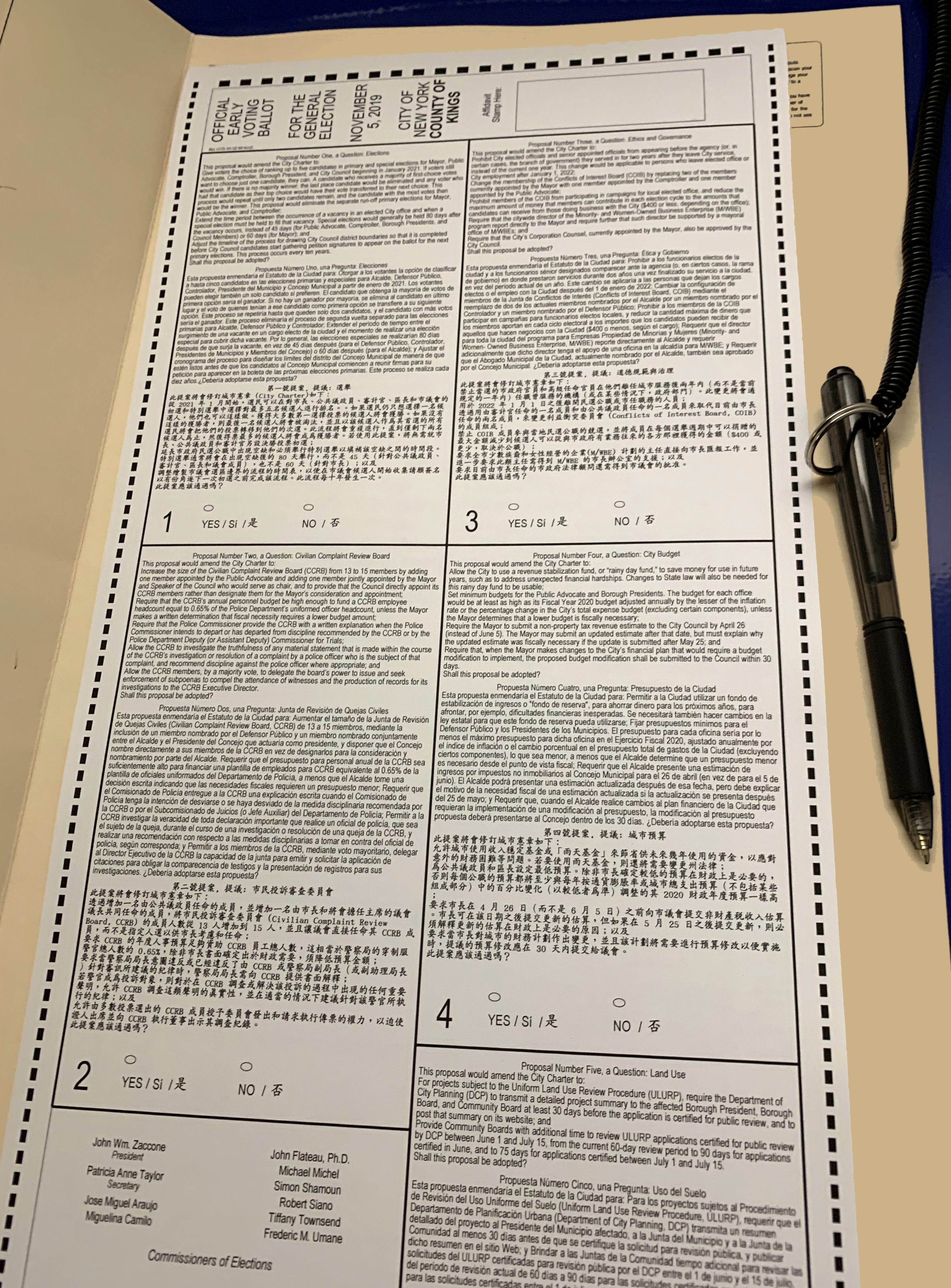 An election official advises that people read their voter guide before coming to fill out their ballot, especially because the City Charter proposals are in tiny print and hard to read. Eagle photo by Fay Storrm