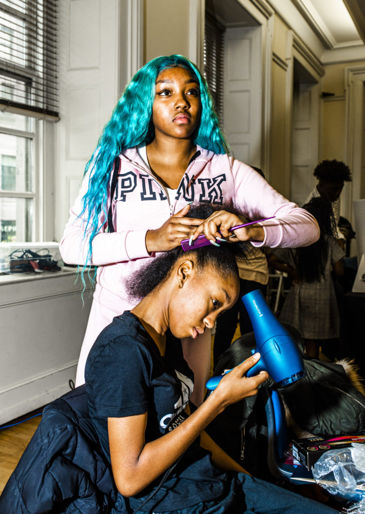 A G-MACC student works on her cousin's hair. One goal of the workshop was to give students substantive entrepreneurship experience, setting itself apart from job skills and training courses that often focus on students being employees instead of employers. Photo by Mark Davis