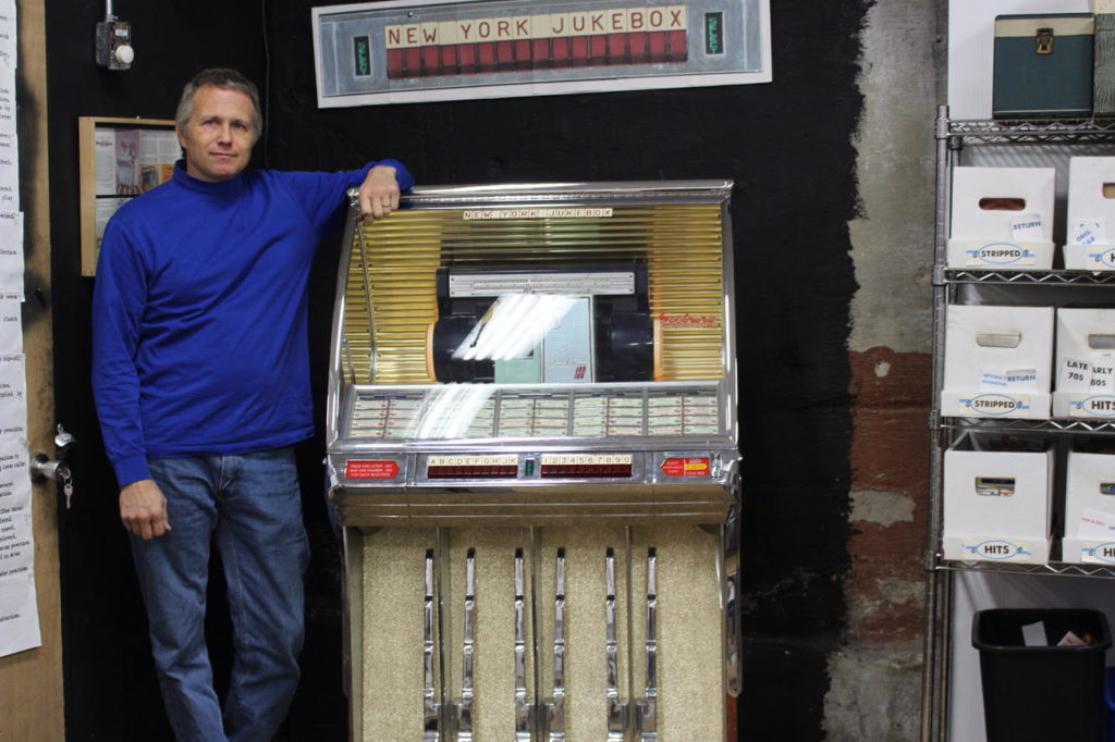 Terence Swords poses with one of his jukeboxes. Photo by Michael Stahl
