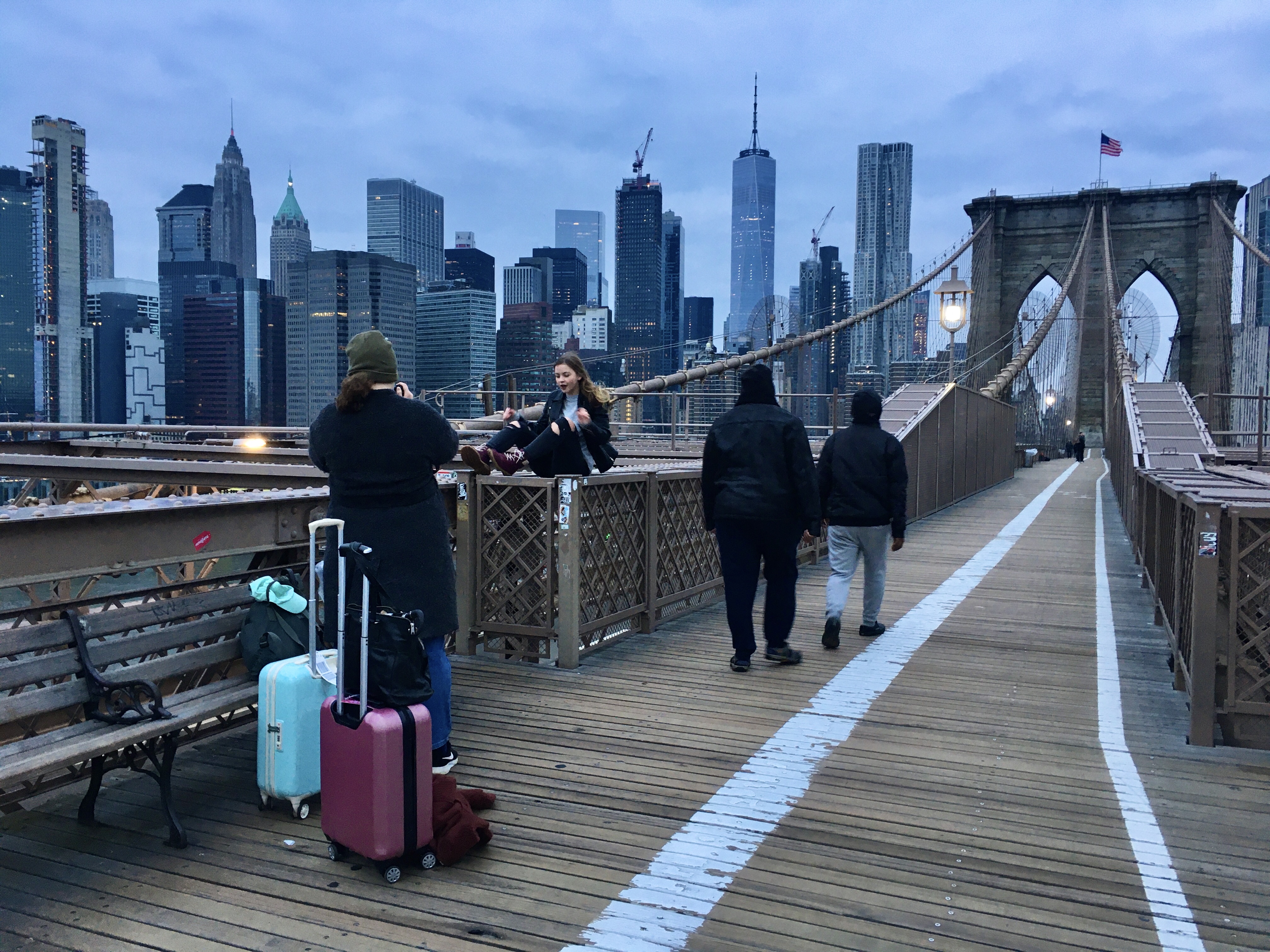 A visitor strikes a pose on the Brooklyn Bridge on a December dawn. Photo: Lore Croghan/Brooklyn Eagle